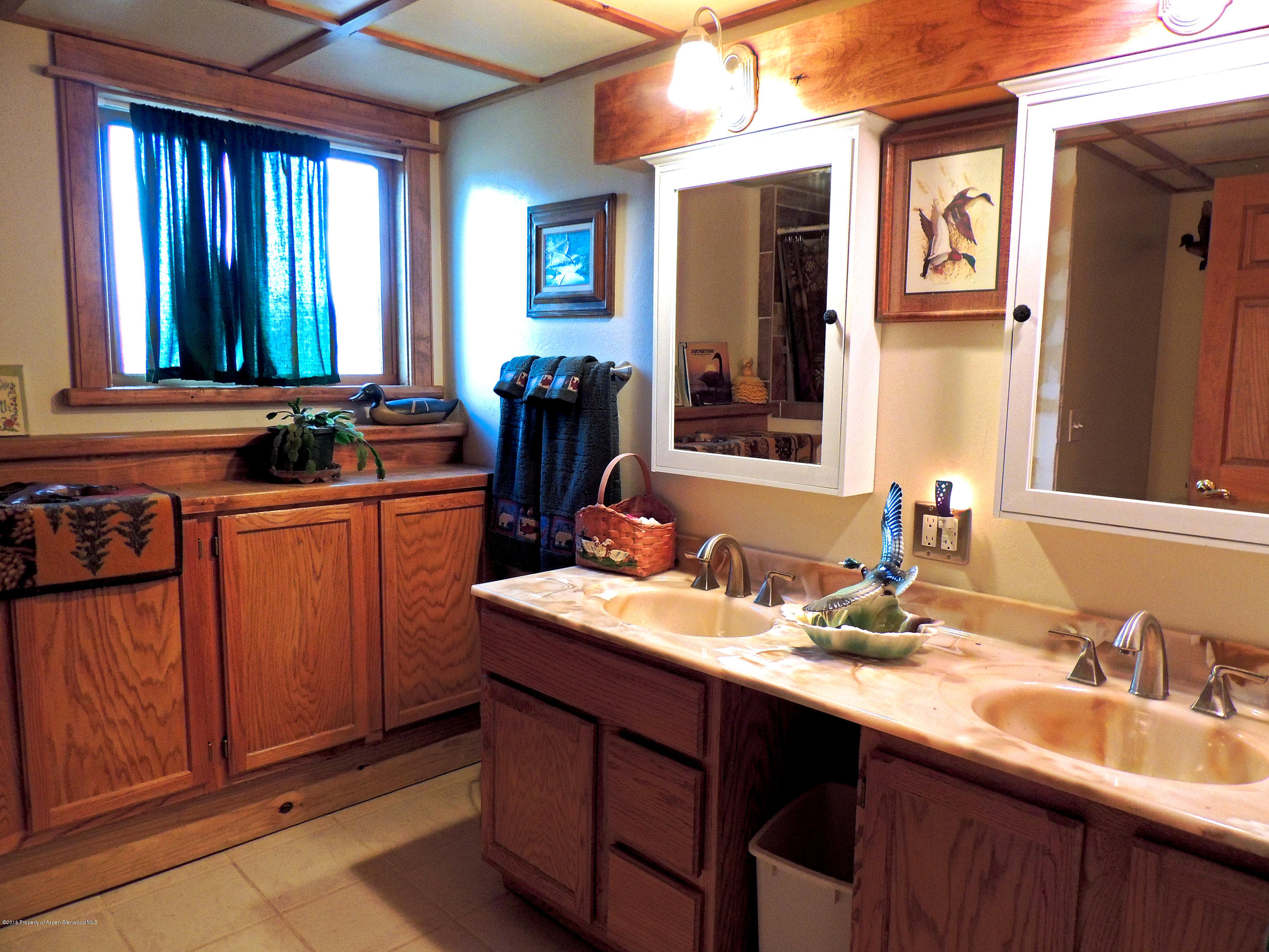277 Miller Lane Rifle, CO 81650 - Photo 22 of 22 a bathroom with a double vanity sink and a mirror