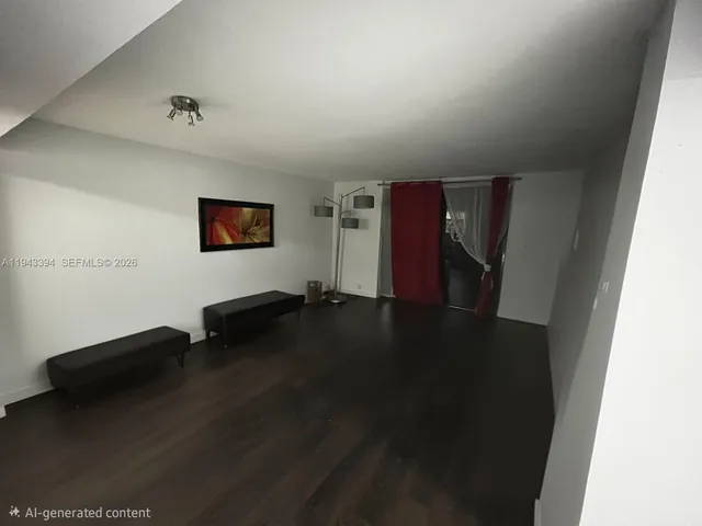 a view of a livingroom with an empty space and a window