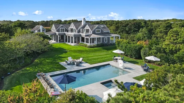 a view of a house with a yard and sitting area