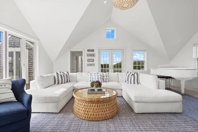 a living room with furniture a fireplace and a large window