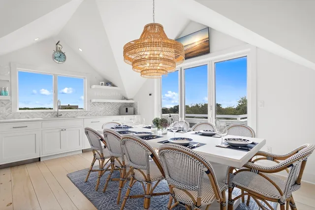 a kitchen with stainless steel appliances a table chairs and a chandelier