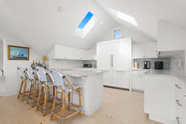 a kitchen with white cabinets and white appliances