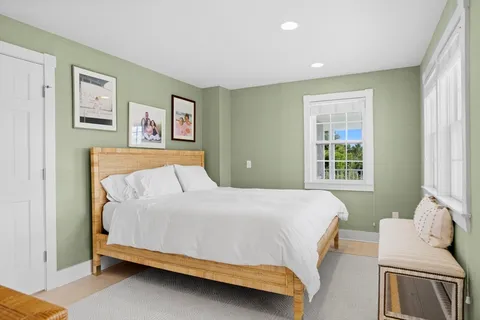 a bathroom with a granite countertop sink vanity mirror and toilet