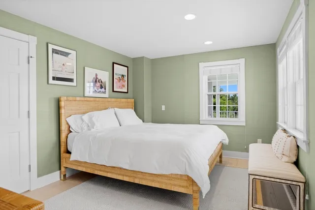 a bathroom with a granite countertop sink vanity mirror and toilet