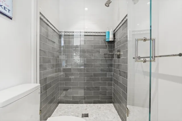 a bedroom with a large bed and a couch