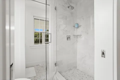 a large white bed in a white room