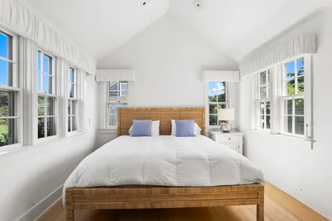 a front view of a house with a garden and porch