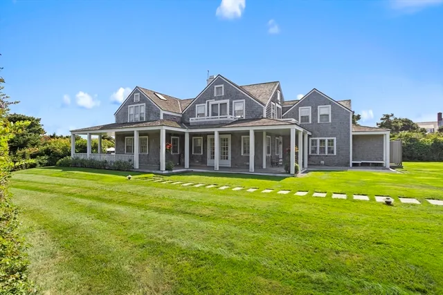 a front view of a house with a yard table and chairs
