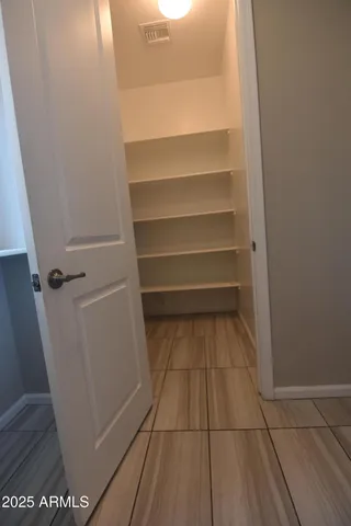 a view of staircase with lots of frames on wall and stairs