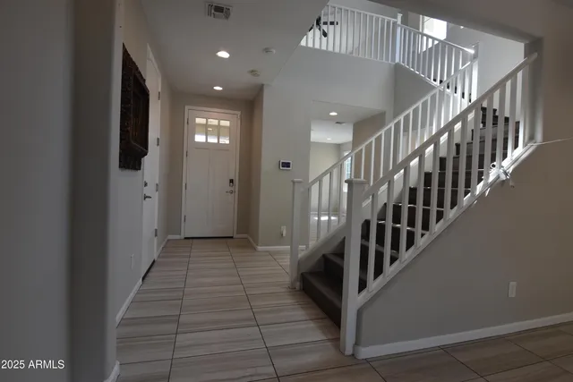 a view of entryway and hall with wooden floor