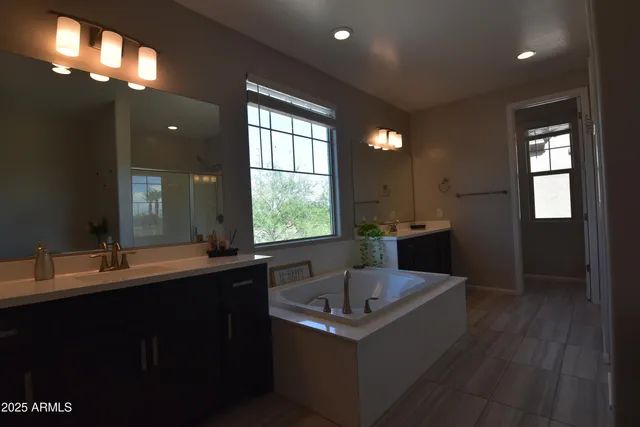 a bathroom with a sink double vanity and a mirror