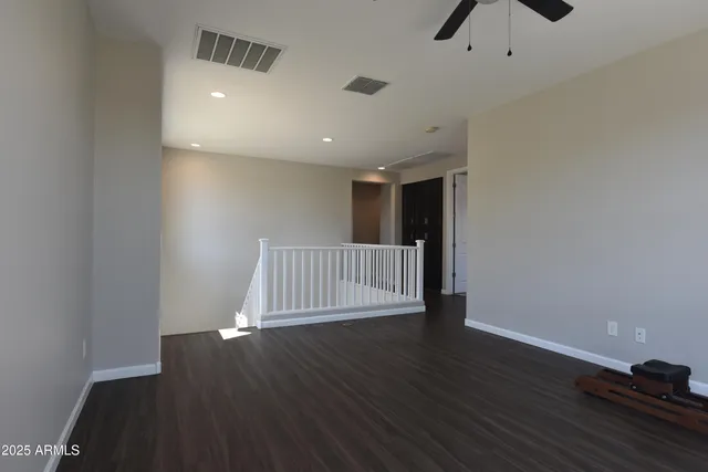 an empty room with windows and a flat screen tv