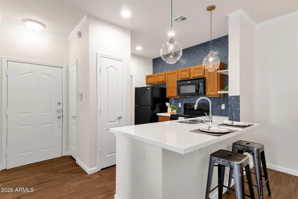 a kitchen with stainless steel appliances a refrigerator sink and microwave