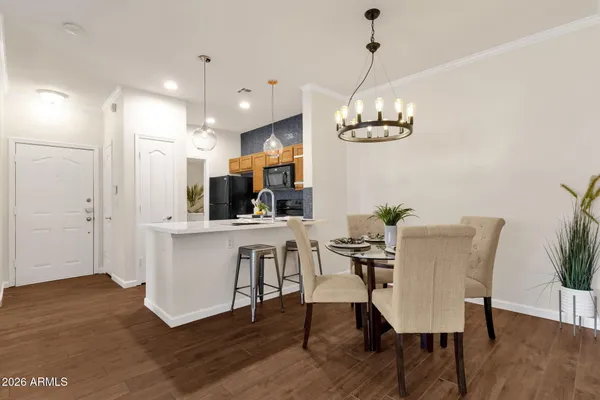 a living room with furniture a fireplace and a chandelier