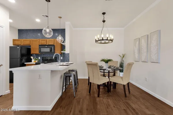 a kitchen with stainless steel appliances granite countertop a sink and a refrigerator