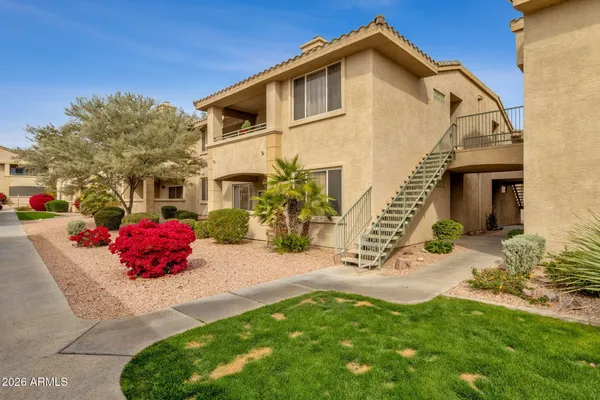 front view of a brick house with a yard