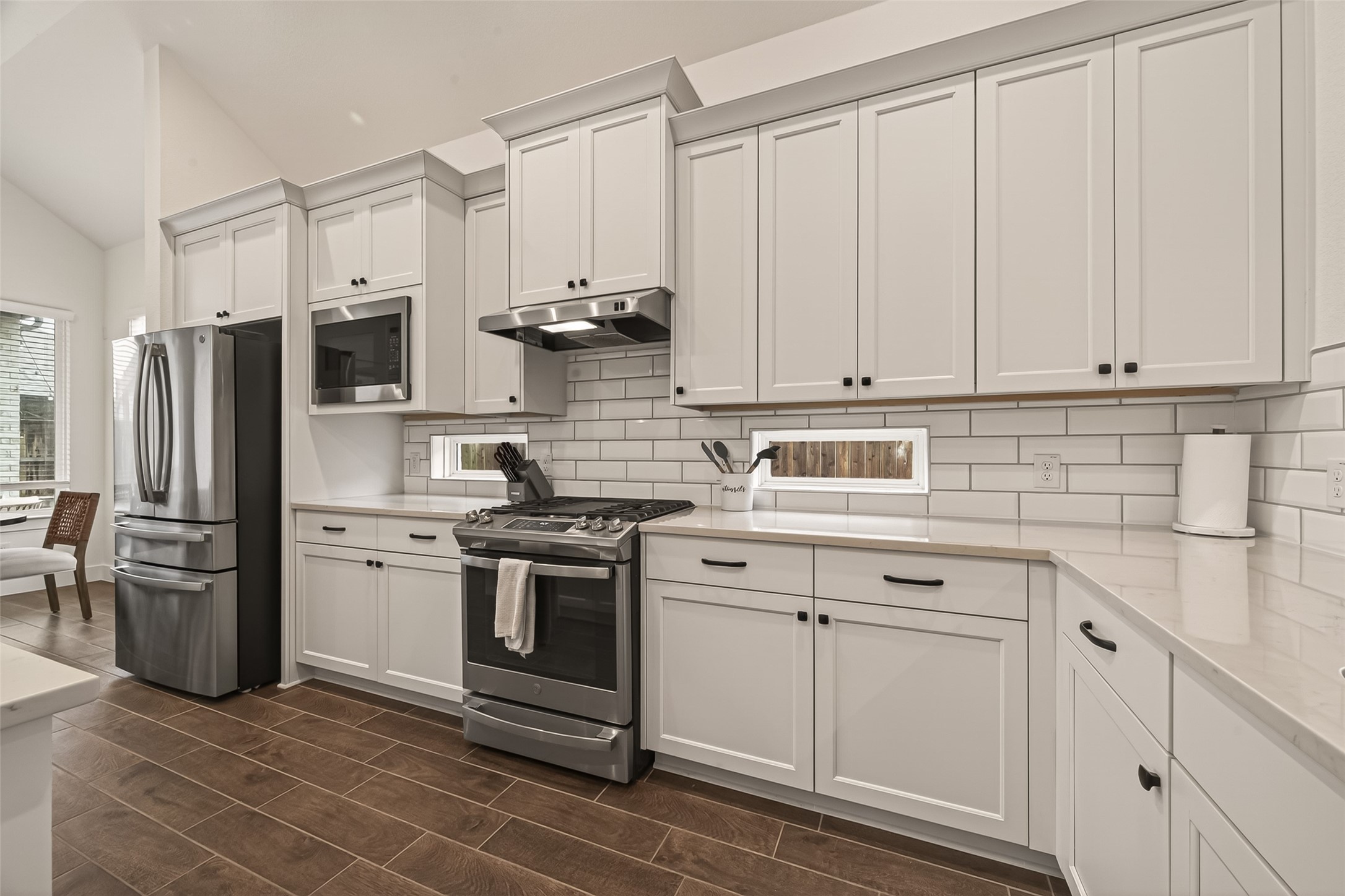 5019 Country Mdws Trail Rosharon, TX 77583 - Photo 12 of 49 a kitchen with stainless steel appliances white cabinets and a stove top oven