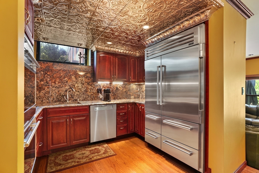 131 Perkins Street, Unit 131 Boston, MA 02130 - Photo 7 of 21 a kitchen with stainless steel appliances granite countertop a refrigerator and a stove
