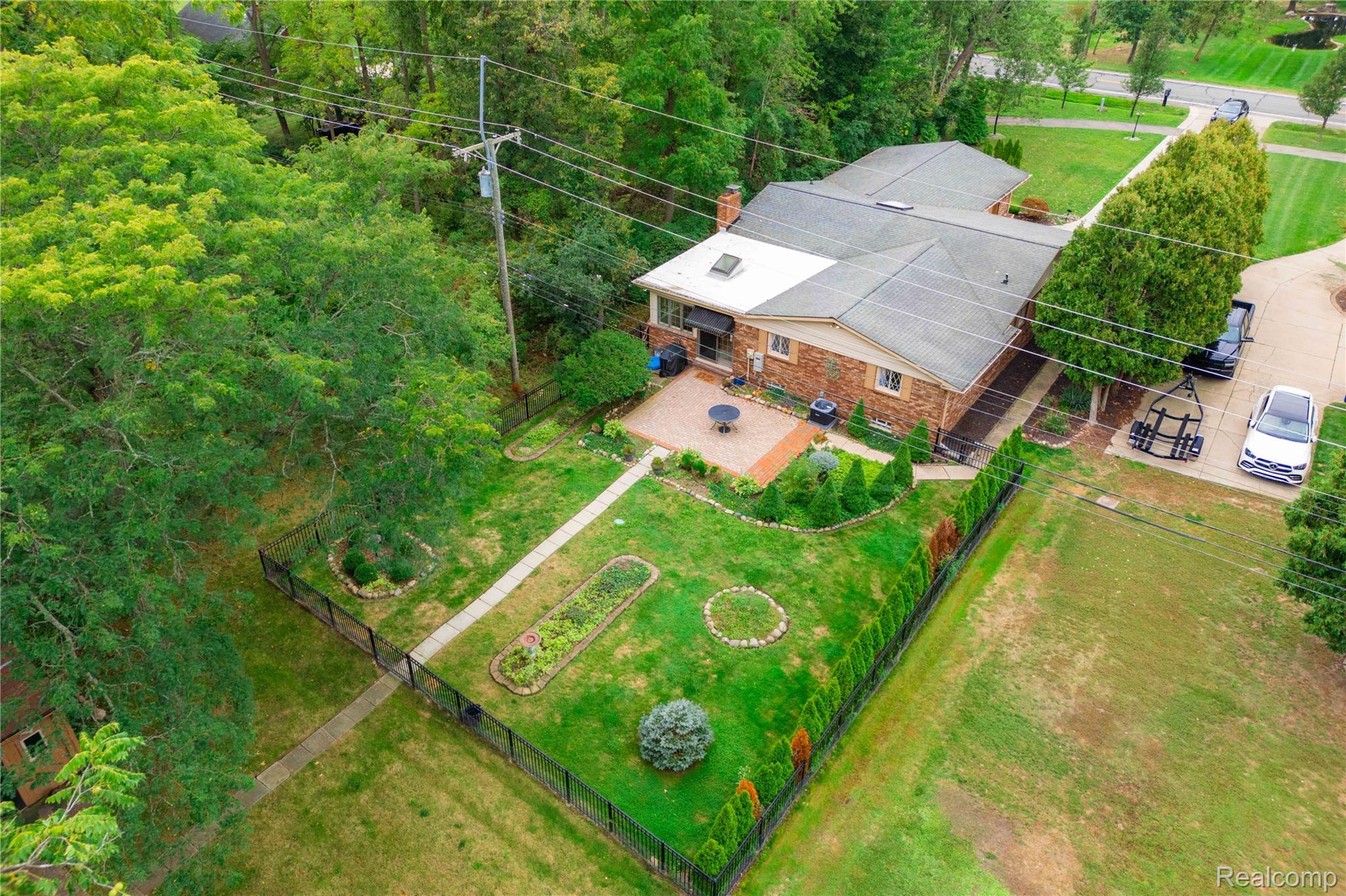 25645 Meridian Road Grosse Ile, MI 48138 - Photo 35 of 46 Brick exterior with a gabled roof and skylight