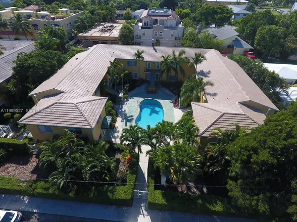 an aerial view of multiple houses with yard