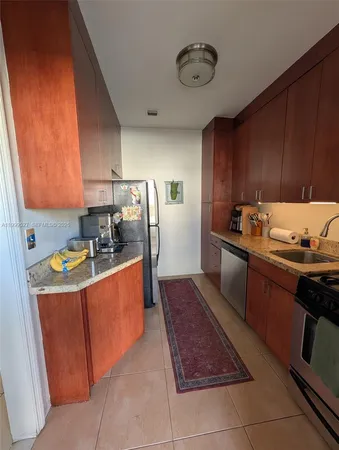 front view of house with a yard and potted plants