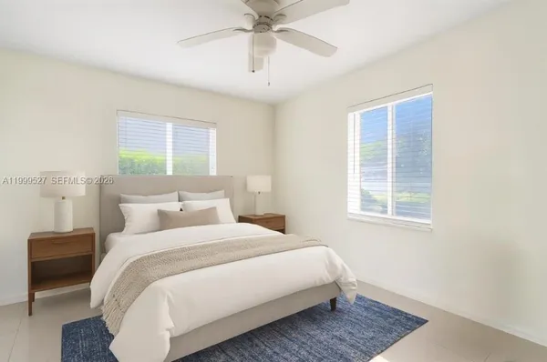 a bedroom with bed and window