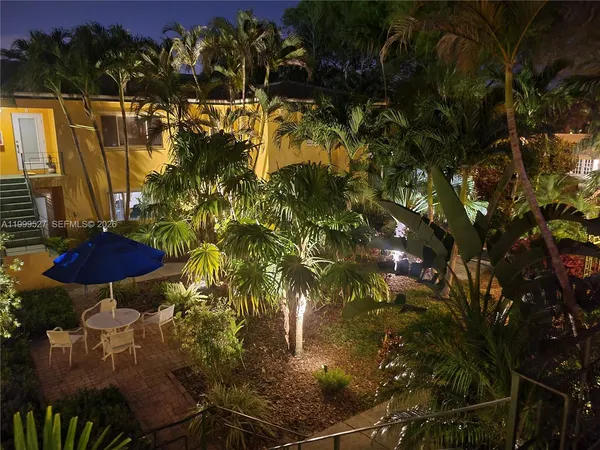 an aerial view of multiple houses with yard