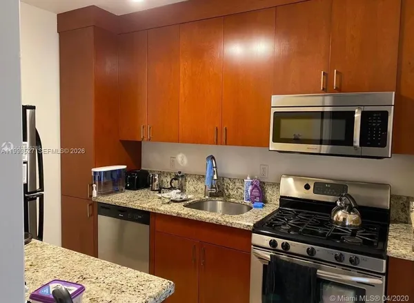 a kitchen with a sink and a stove top oven