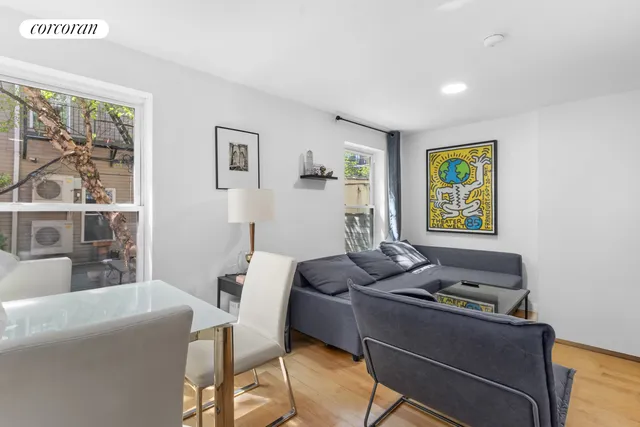 a kitchen with granite countertop wooden floors appliances and cabinets