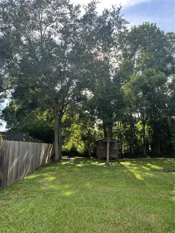 a front view of a house with a yard and a garden