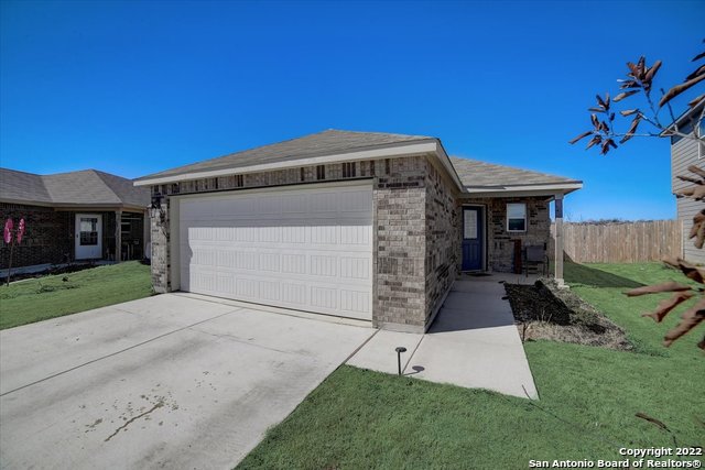 6023 Macdona Ridge San Antonio, TX 78252 - Photo 1 of 1 a front view of a house with a yard