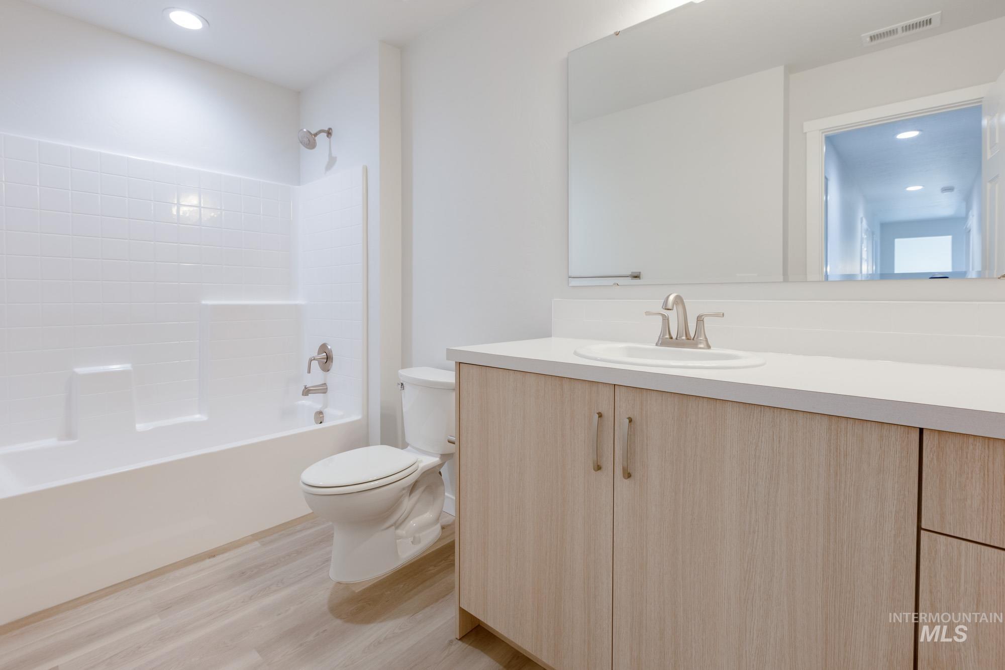 1639 Celina Street Middleton, ID 83644 - Photo 18 of 19 Contemporary bathroom featuring a light wood-finish vanity with a white countertop and integrated sink