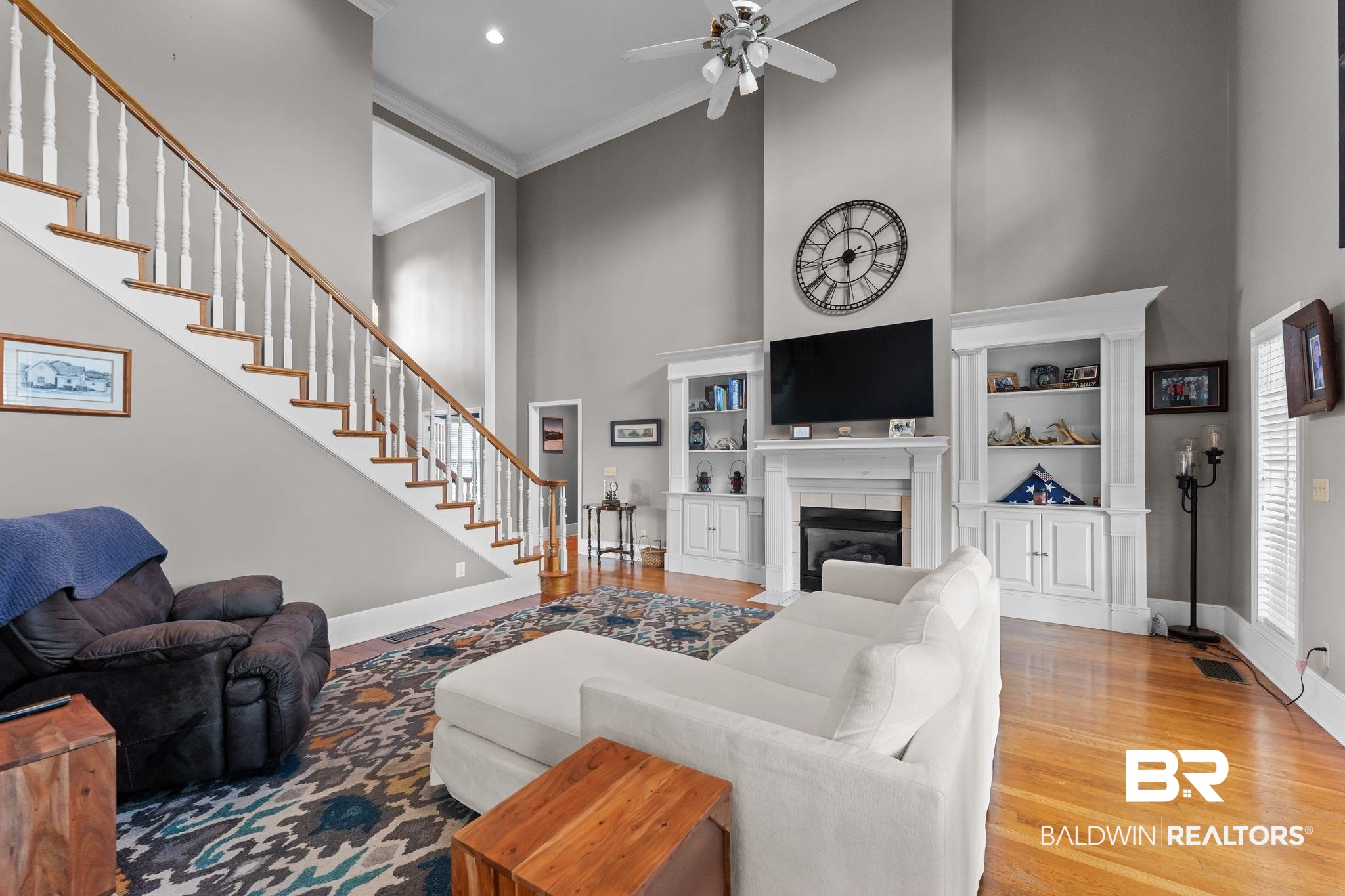 525 Norwood Road Monroeville, AL 36460 - Photo 6 of 55 Living area featuring a high ceiling, stairway, light wood finished floors, crown molding, and a fireplace