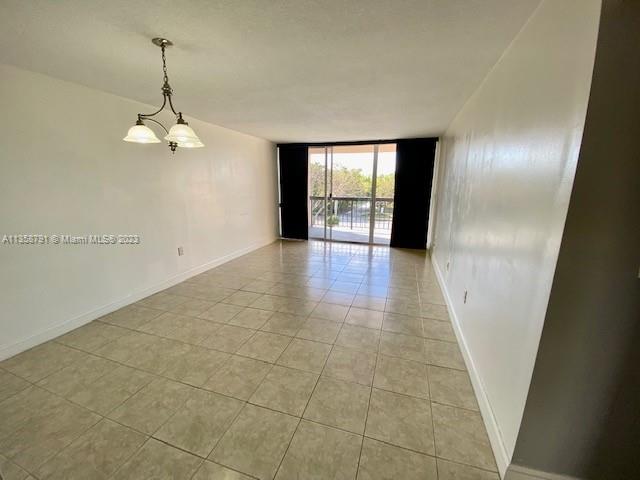 10985 Southwest 107th Street, Unit 305 Miami, FL 33176 - Photo 4 of 20 wooden floor in an empty room with a window