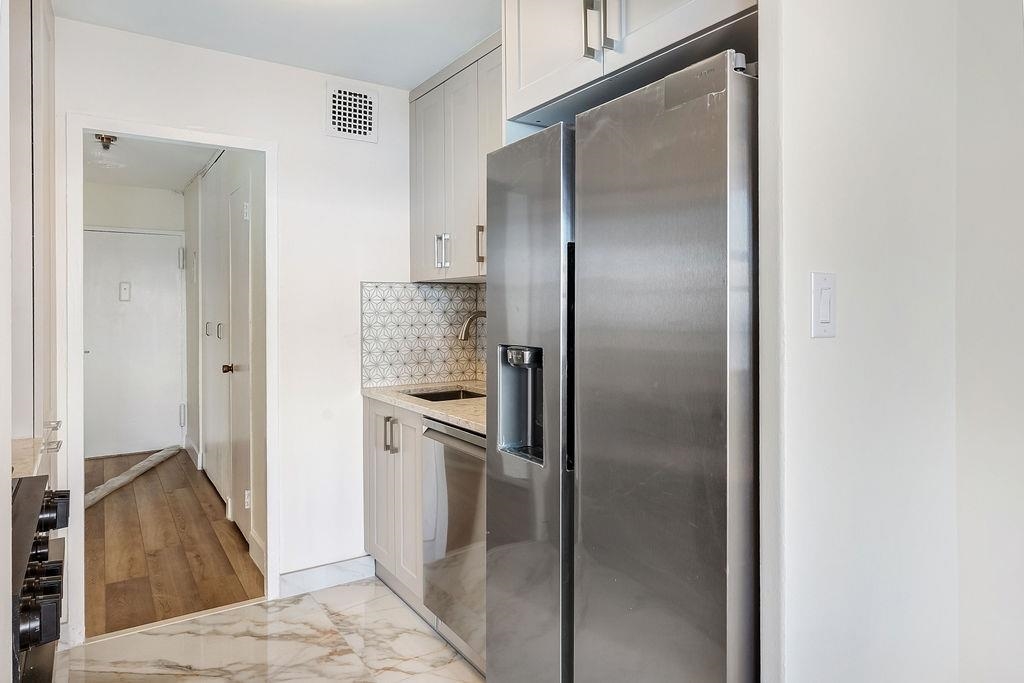 6040 Boulevard East, Unit 22F West New York, NJ 07093 - Photo 15 of 44 a kitchen with a refrigerator and a sink