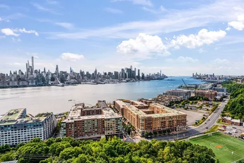 a terrace with outdoor seating and city view
