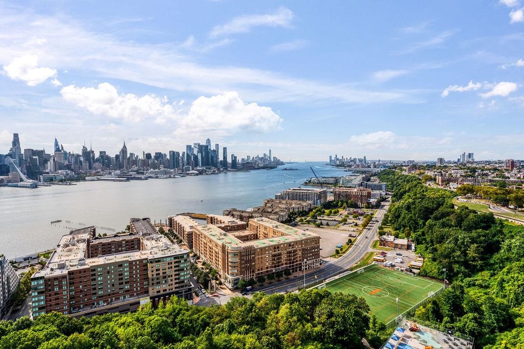 6040 Boulevard East, Unit 22F West New York, NJ 07093 - Photo 27 of 44 a view of a lake with tall buildings