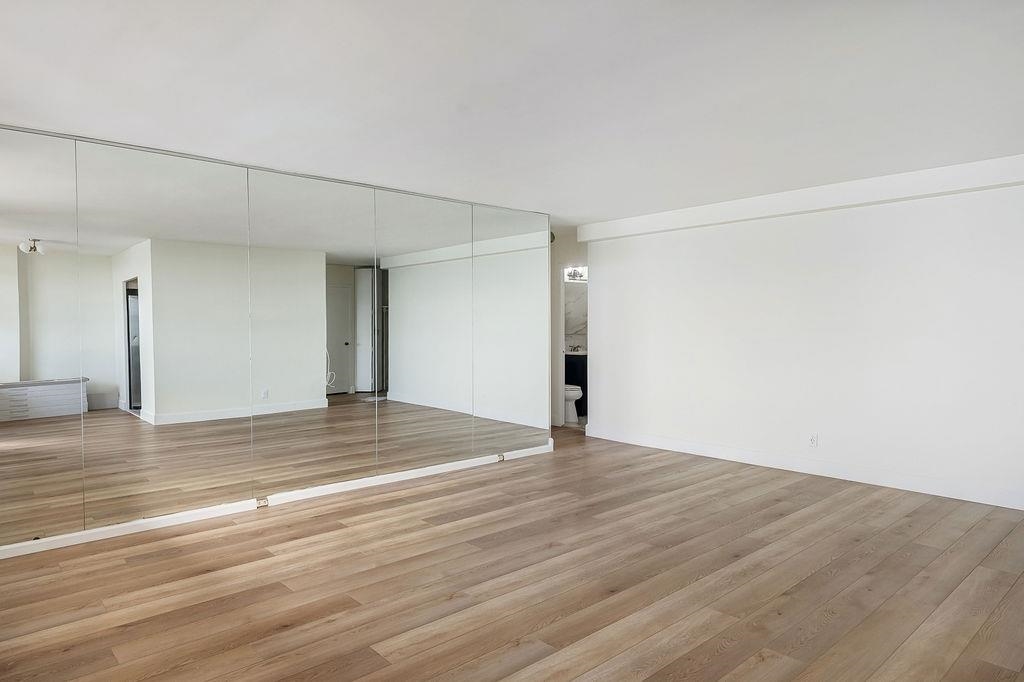 6040 Boulevard East, Unit 22F West New York, NJ 07093 - Photo 8 of 44 a view of empty room with wooden floor