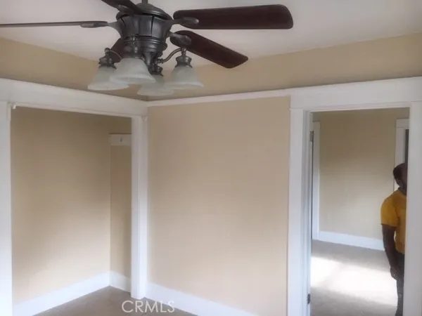 a view of hallway with a chair