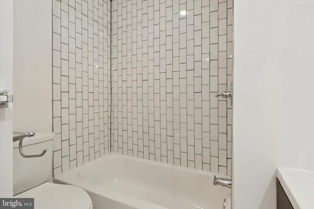 a bathroom with a toilet and a bathtub