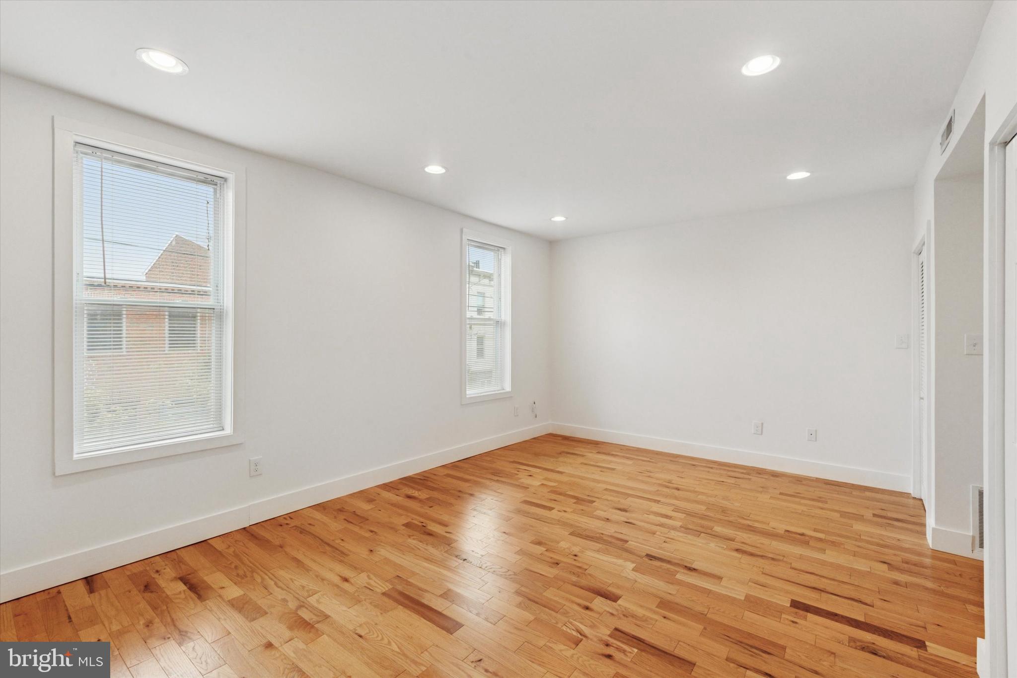 1014 North 4th Street, Unit 2 Philadelphia, PA 19123 - Photo 4 of 16 an empty room with wooden floor and windows