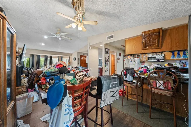 a view of a dining room with furniture and a chandelier
