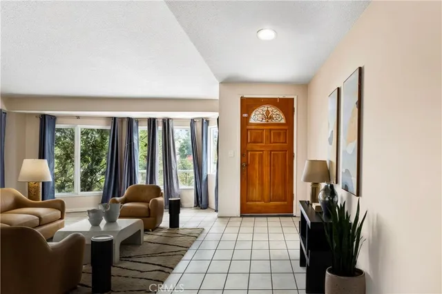 a living room with furniture and a potted plant