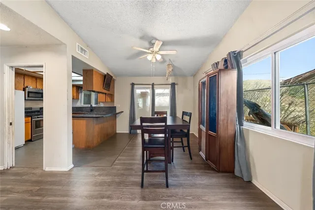 a view of a dining room with furniture window and wooden floor