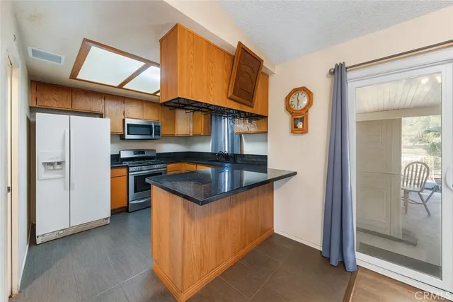 a kitchen with stainless steel appliances granite countertop a stove and a refrigerator