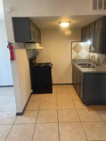 a kitchen with a sink and a stove