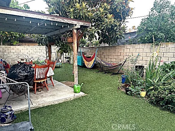 a swimming pool with outdoor seating and yard