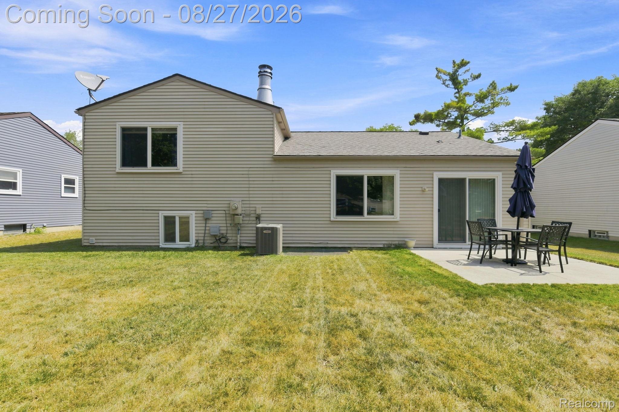 42120 Ridge Road West Novi, MI 48375 - Photo 29 of 32 Expansive backyard featuring a concrete patio and a sliding glass door