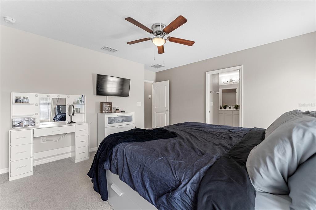 3523 Clay Brick Road St. Cloud, FL 34773 - Photo 24 of 62 a bedroom with a large bed and a large window