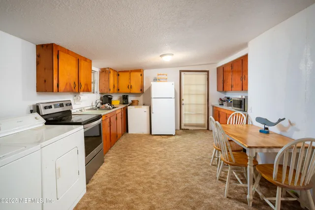 a kitchen that has a cabinets counter space and appliances